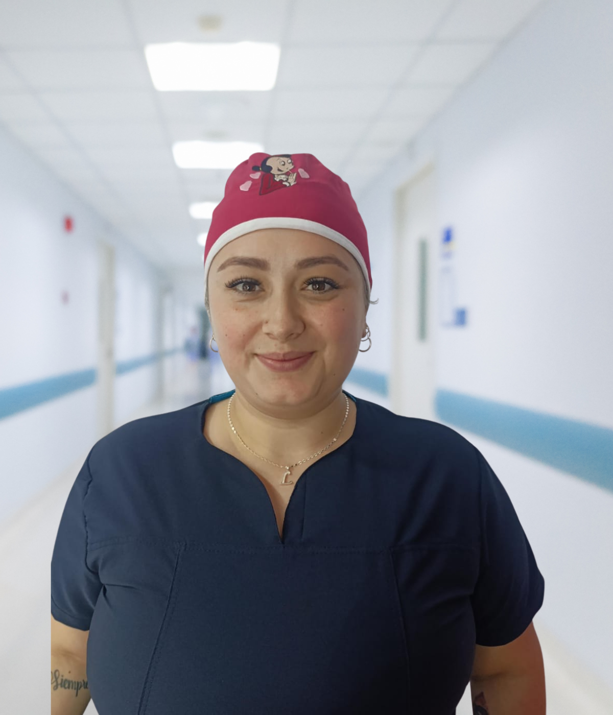 Gorro antifluido unisex color fucsia con bordado decorativo de Olivia en la parte frontal.